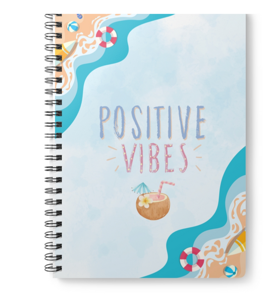 Digital mockup of a notebook with 'Positive Vibes' design on a printing platform.